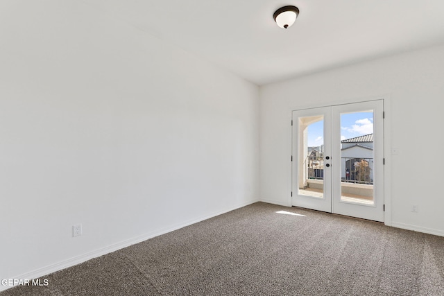 carpeted empty room featuring french doors