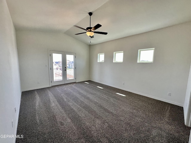 carpeted empty room featuring french doors, vaulted ceiling, ceiling fan, and a healthy amount of sunlight