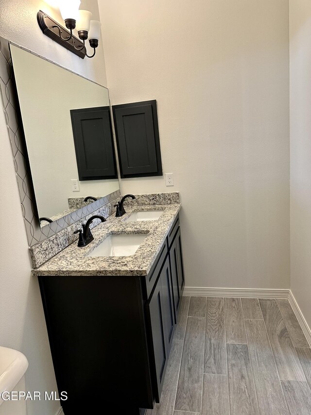 bathroom featuring vanity, toilet, and wood-type flooring