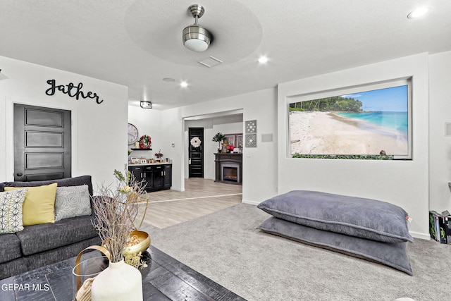 bedroom featuring wood-type flooring, a textured ceiling, a closet, and ceiling fan