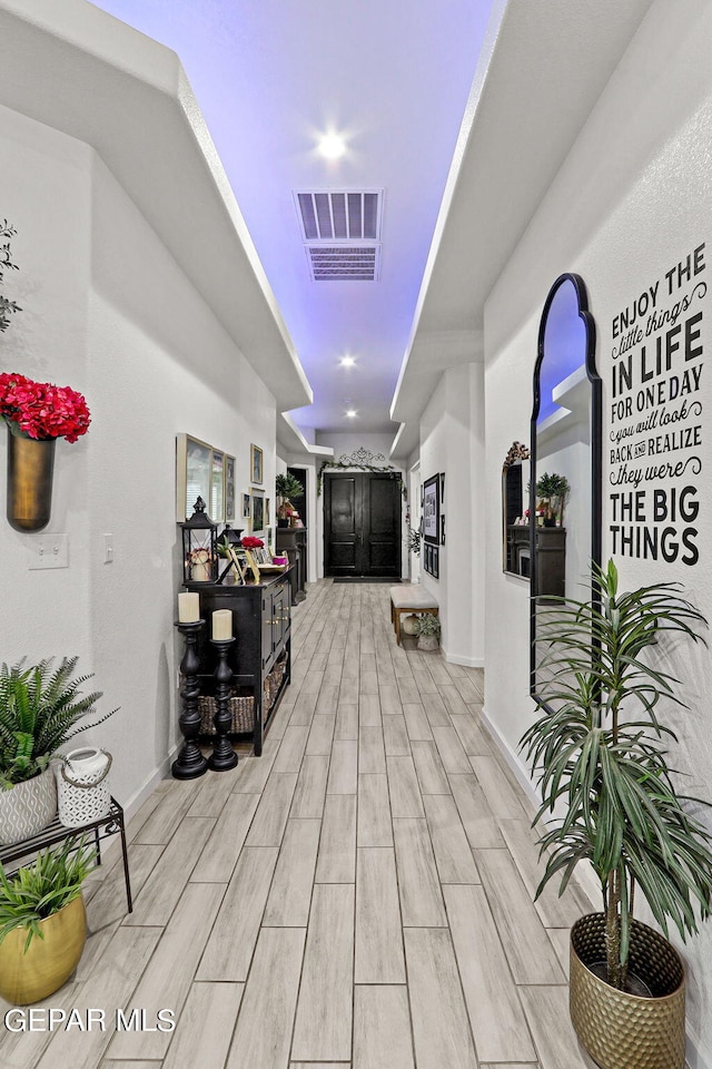 corridor featuring light hardwood / wood-style floors