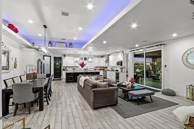 living room featuring light hardwood / wood-style flooring and beverage cooler