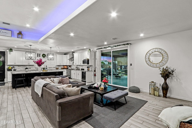 living room with light wood-type flooring and beverage cooler