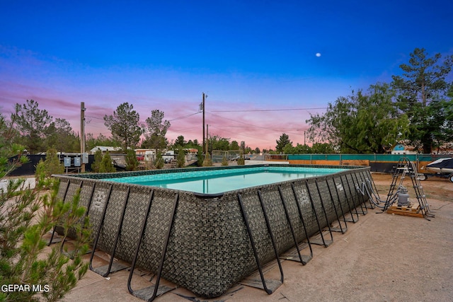 view of pool at dusk