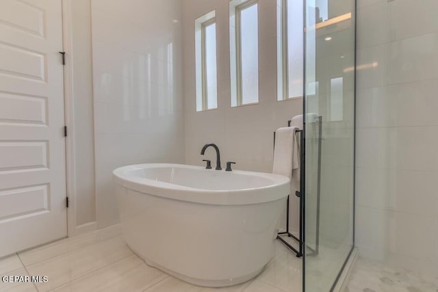 bathroom featuring separate shower and tub and tile patterned flooring