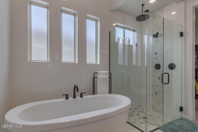 bathroom featuring tile patterned flooring and independent shower and bath