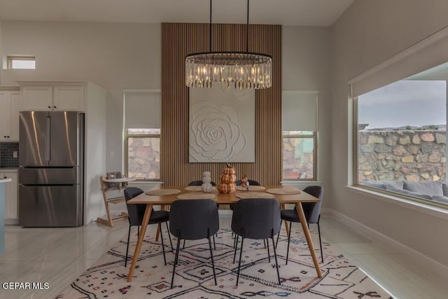 tiled dining space featuring a notable chandelier