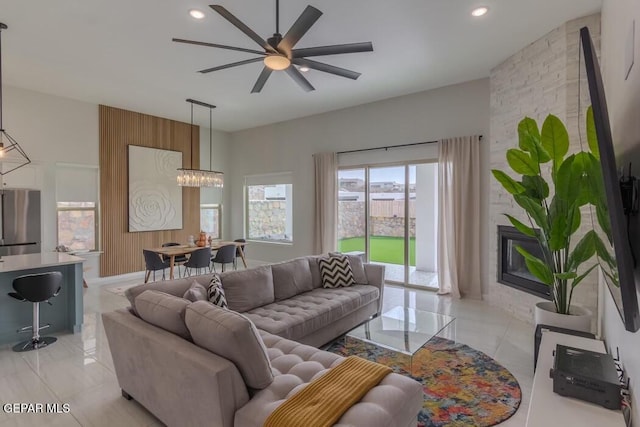 living room featuring ceiling fan with notable chandelier