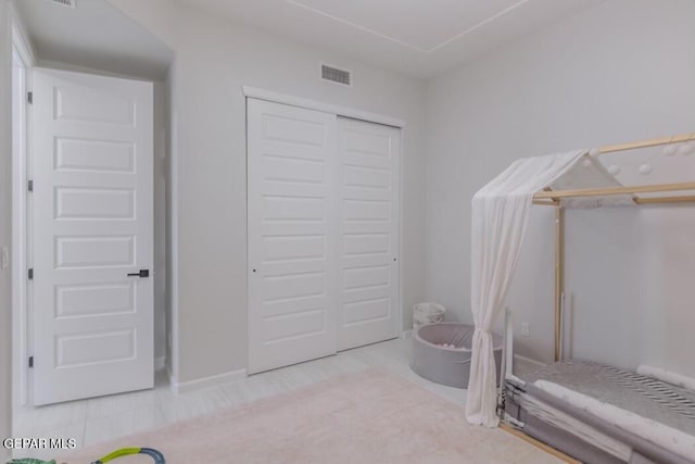 unfurnished bedroom featuring a closet and light tile patterned flooring