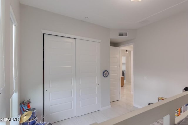 tiled bedroom featuring a closet