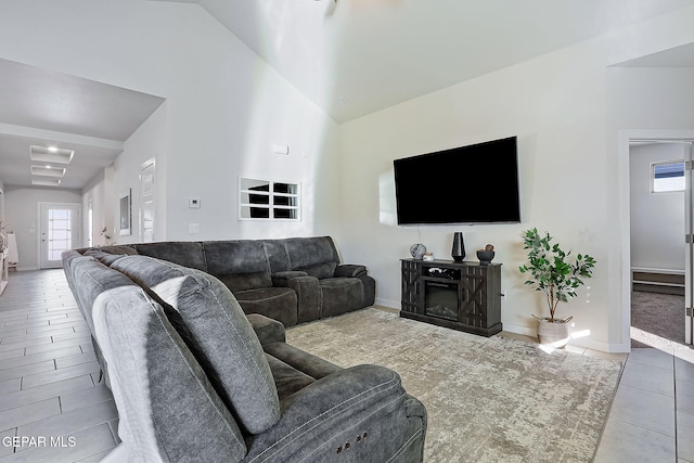 tiled living room featuring lofted ceiling