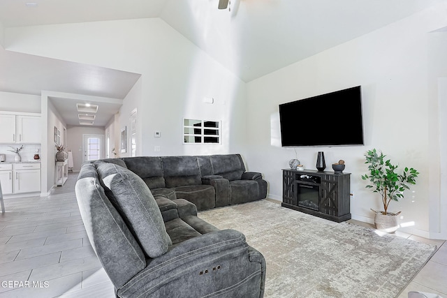 living room featuring high vaulted ceiling