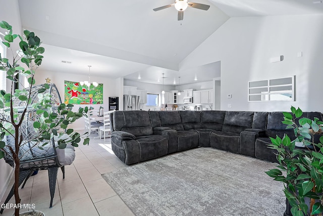 tiled living room featuring high vaulted ceiling and ceiling fan