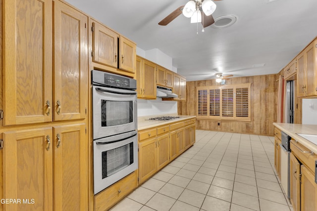 kitchen featuring ceiling fan, sink, light tile patterned floors, and appliances with stainless steel finishes