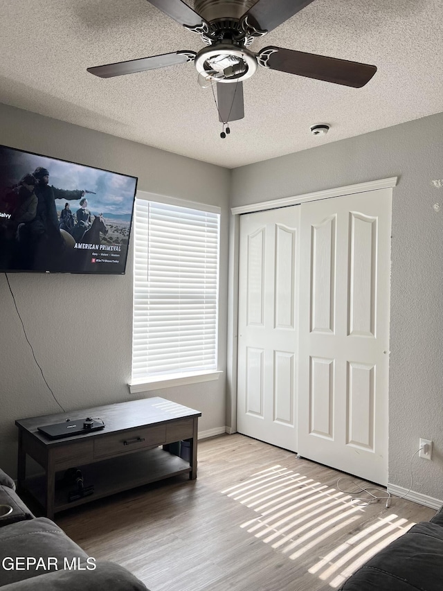 sitting room with a textured ceiling and light hardwood / wood-style flooring