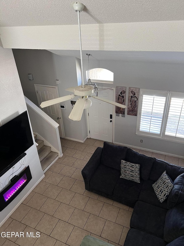 tiled living room featuring ceiling fan