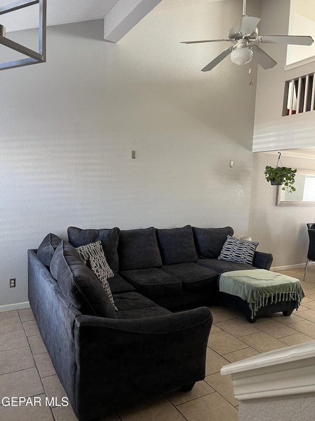 living room featuring lofted ceiling, ceiling fan, and light tile patterned floors