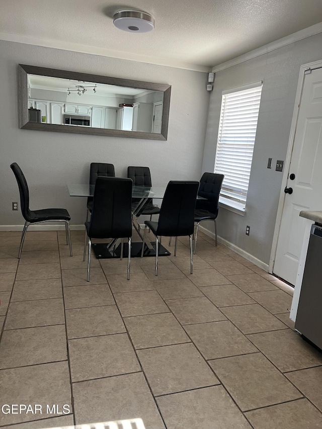 tiled dining space with ornamental molding and ceiling fan