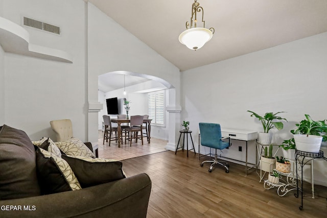 office with hardwood / wood-style floors and high vaulted ceiling