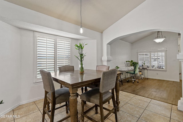 dining room featuring light hardwood / wood-style floors and vaulted ceiling