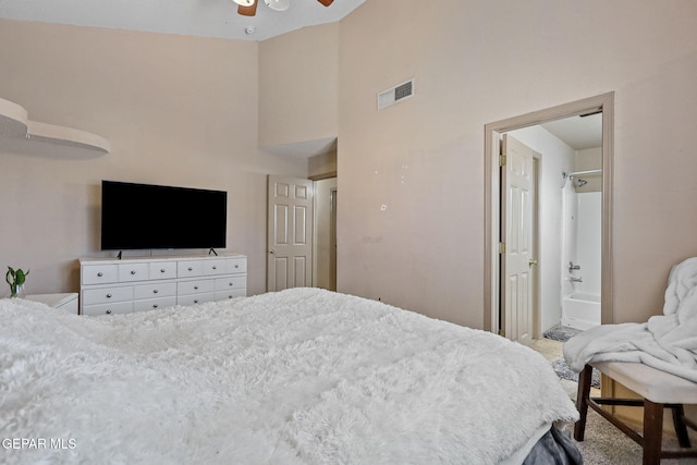 bedroom with carpet, a high ceiling, ensuite bathroom, and ceiling fan