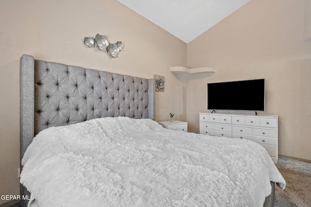 bedroom featuring carpet flooring and vaulted ceiling