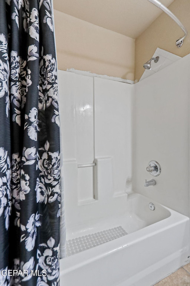 bathroom featuring tile patterned flooring and shower / bathtub combination with curtain