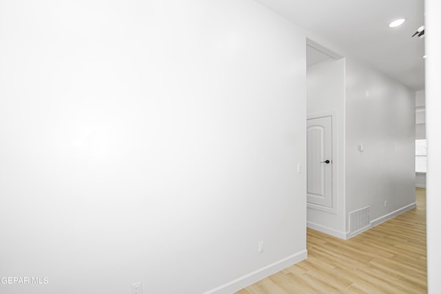 corridor with light hardwood / wood-style floors