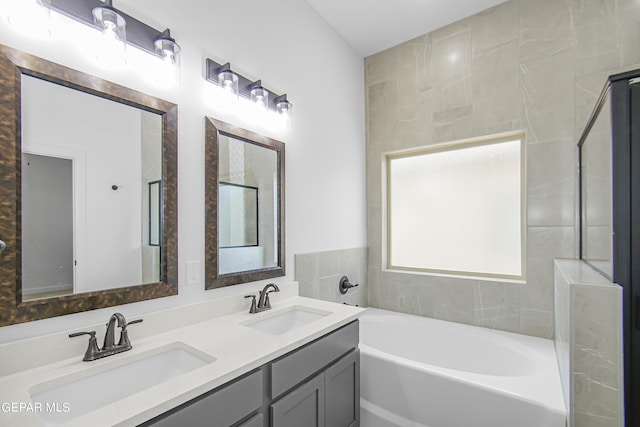 bathroom featuring vanity and a bath