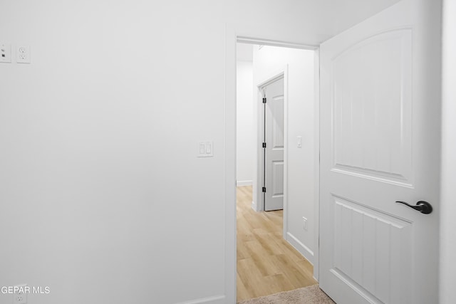 hall with light hardwood / wood-style floors