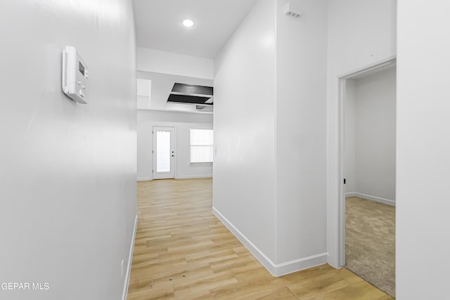 corridor with light hardwood / wood-style flooring