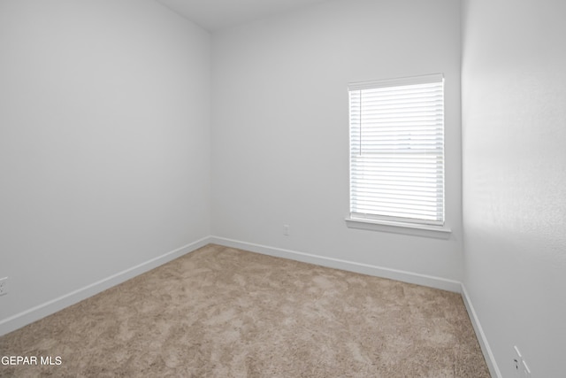 unfurnished room featuring light carpet