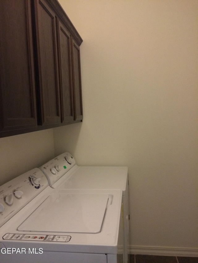 washroom featuring cabinets and separate washer and dryer