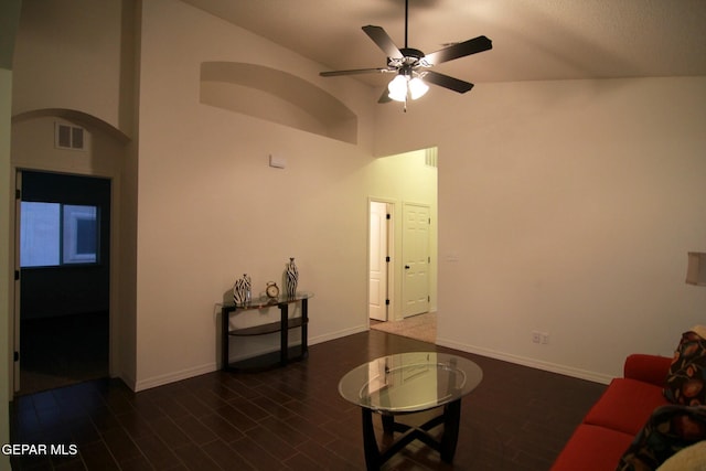 living room with ceiling fan and high vaulted ceiling