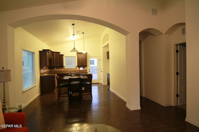 dining room featuring dark hardwood / wood-style floors and lofted ceiling