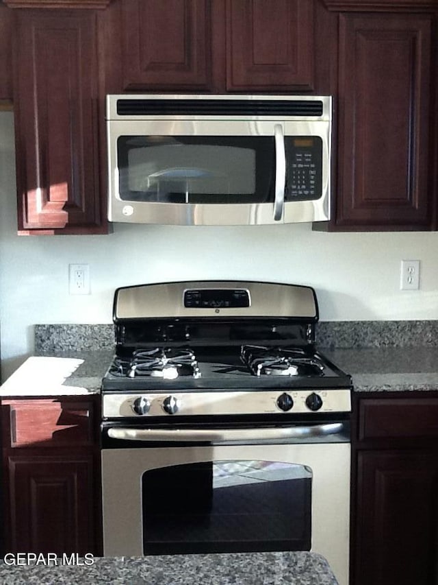 kitchen with light stone countertops and stainless steel appliances