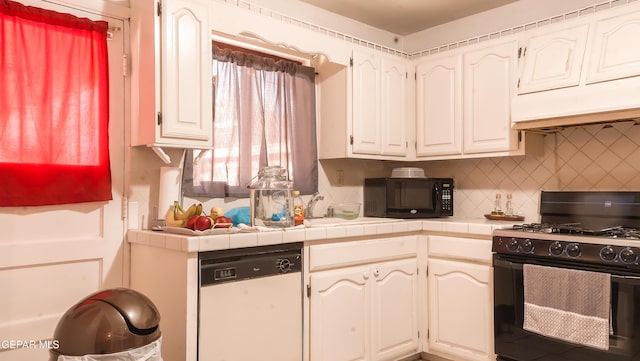 kitchen with white cabinetry, tile counters, tasteful backsplash, and black appliances