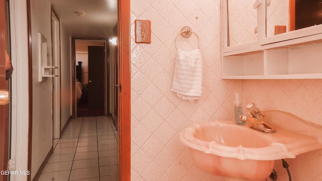 bathroom with tile walls and tile patterned floors