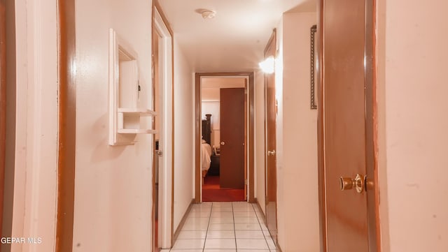 hall with light tile patterned floors