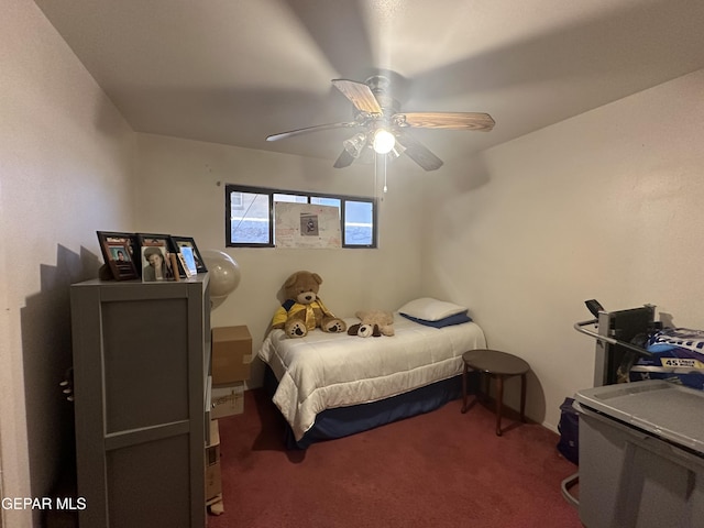 bedroom featuring ceiling fan and dark carpet