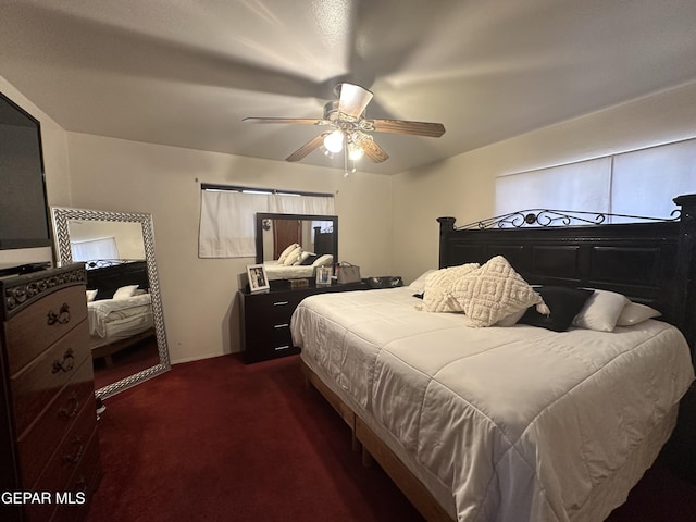 bedroom with dark colored carpet and ceiling fan