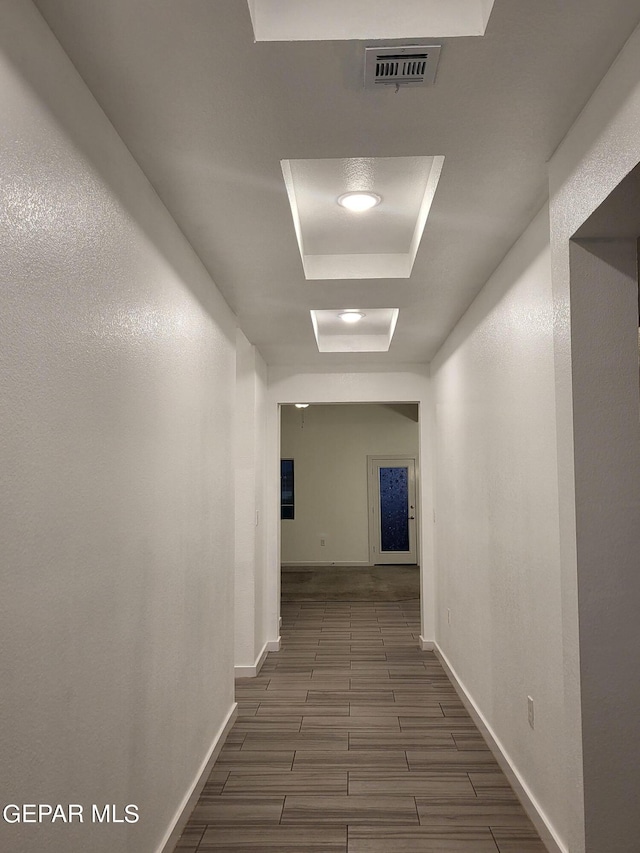 hall with a tray ceiling