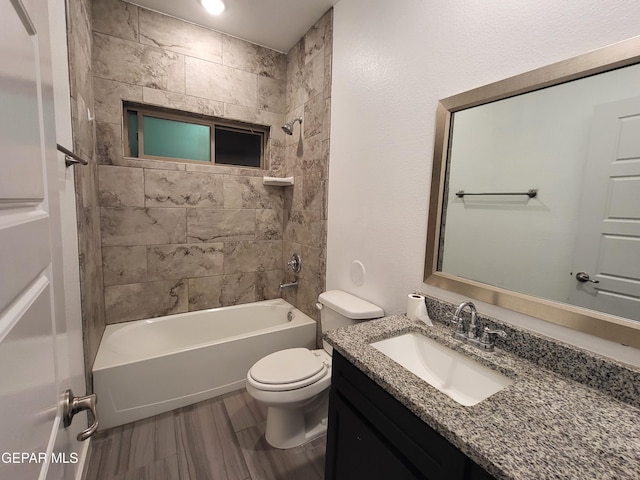 full bathroom with vanity, wood-type flooring, tiled shower / bath combo, and toilet