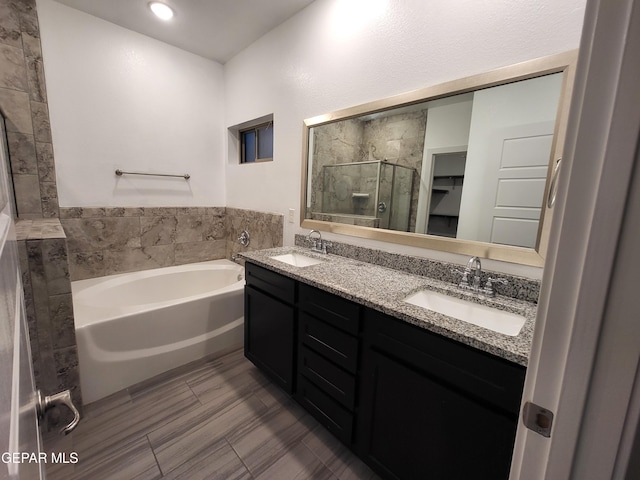 bathroom with separate shower and tub and vanity