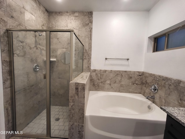 bathroom with vanity and independent shower and bath