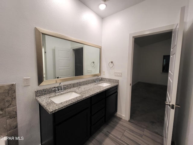 bathroom with vanity and lofted ceiling