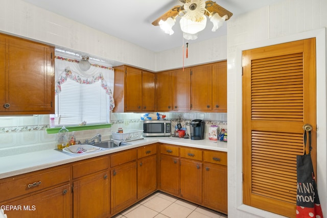 kitchen featuring light tile patterned floors, sink, and tasteful backsplash