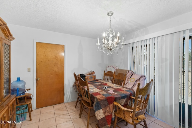 dining space featuring a textured ceiling, an inviting chandelier, and light tile patterned flooring