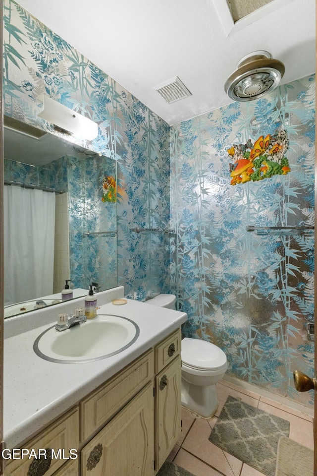 bathroom with tile patterned flooring, vanity, toilet, and a shower with shower curtain