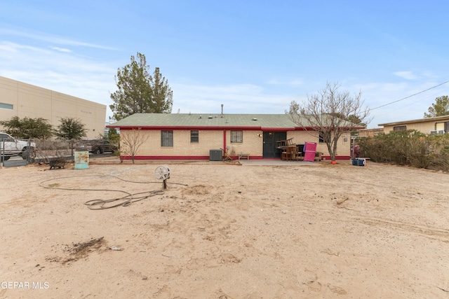 rear view of property featuring a patio area and central air condition unit